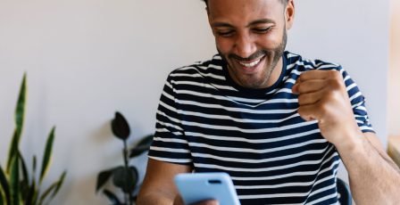 Man gaming online with his mobile phone