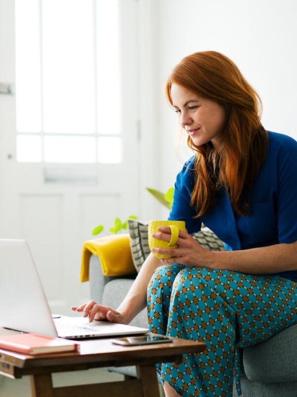 Woman at home applying for credit on her laptop