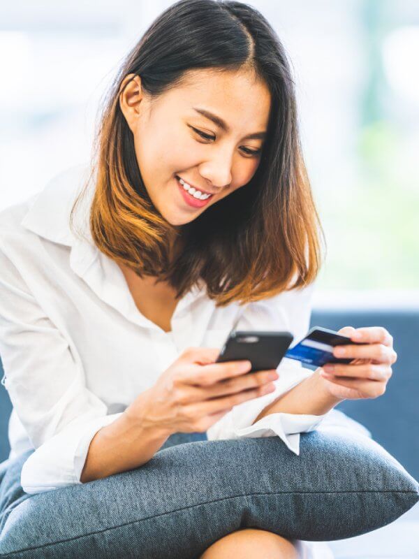 Young woman shopping online on her mobile phone
